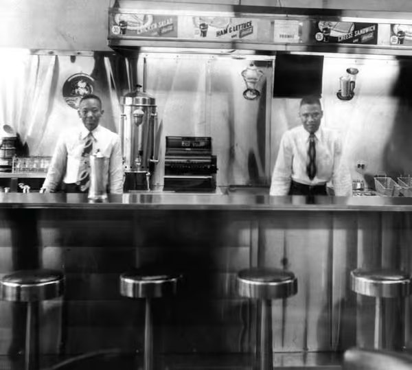 Two men behind the original Paschal's soda and sandwich counter